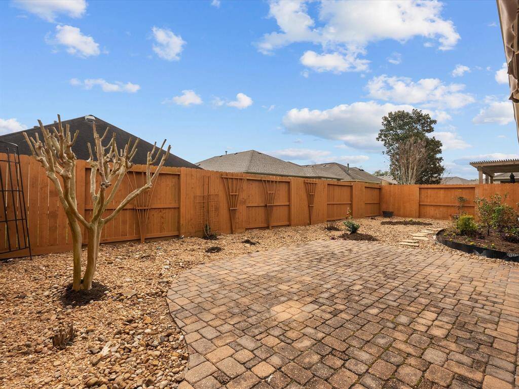 This outdoor space offers a low-maintenance, plus sprinklers front and backyard!