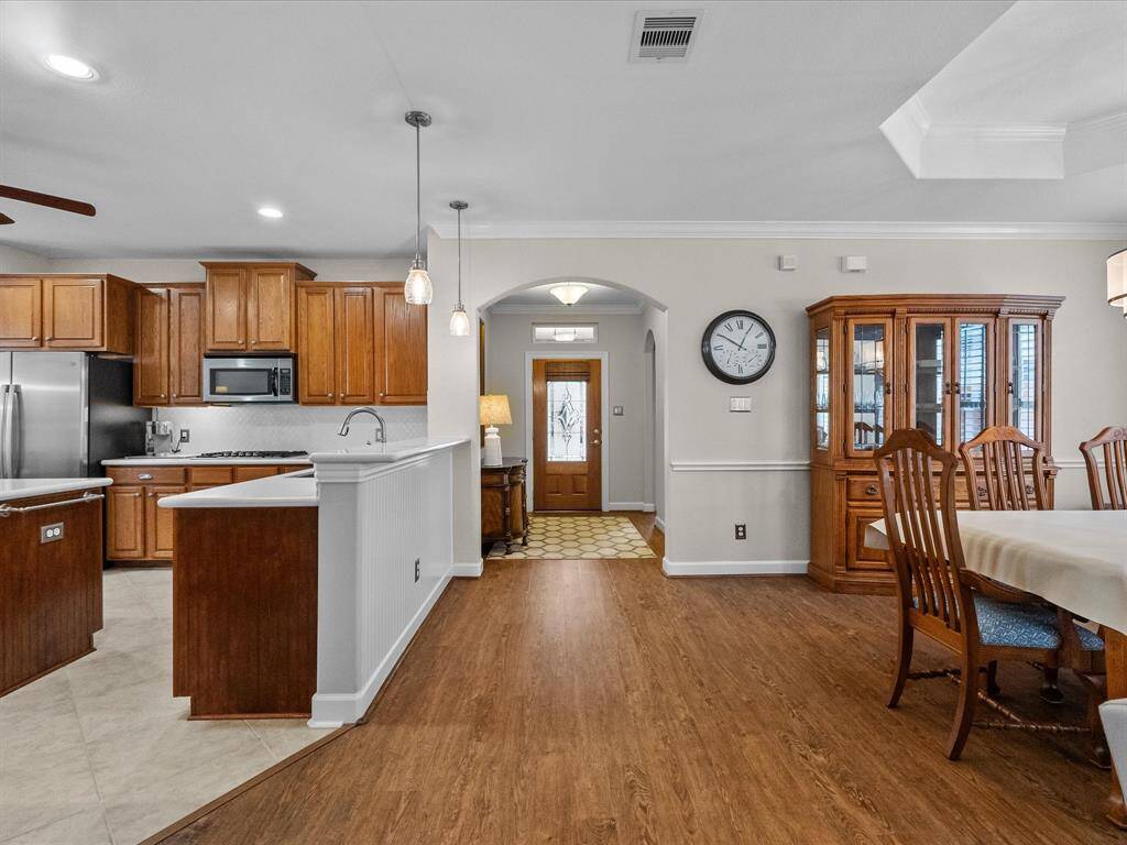 Flowing layout from kitchen to dining area, showcasing an open design.