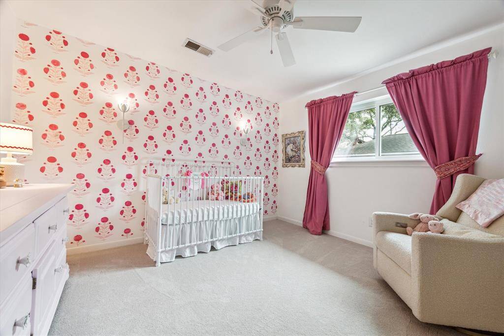 The fourth bedroom is well-lit with natural light and has a ceiling fan for additional comfort.