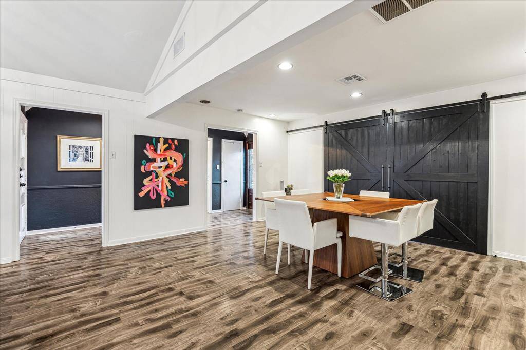 The dining room is open to the Living Room, and has access to the office/playroom area. It features barn doors for the option to open up space, or conceal it.