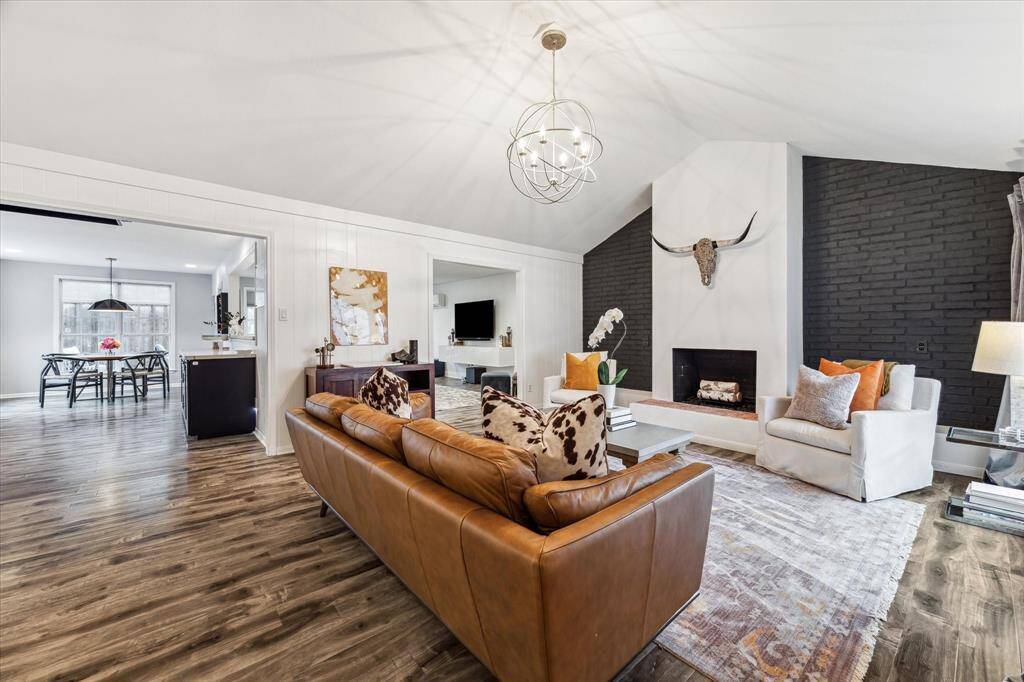 The spacious living area features a modern open layout seamlessly connecting to the dining area and kitchen.