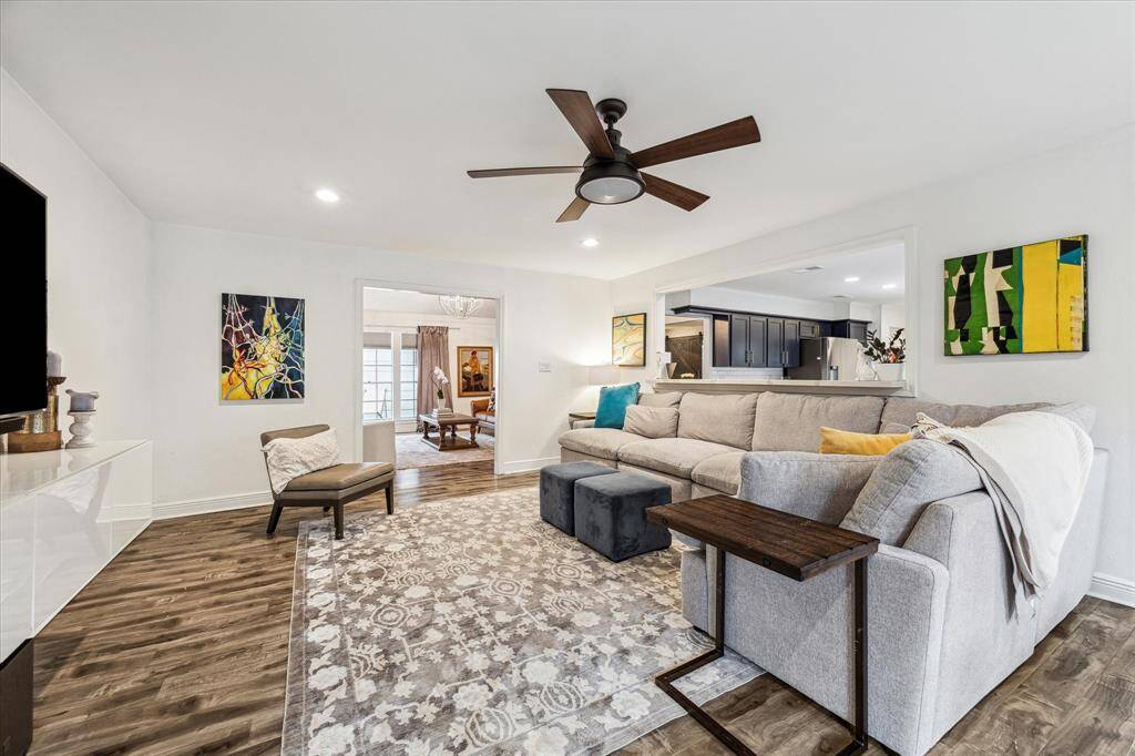 The inviting family room opens to the dining room and kitchen, creating a great flow. The warm wood flooring and natural lighting enhances the cozy atmosphere.