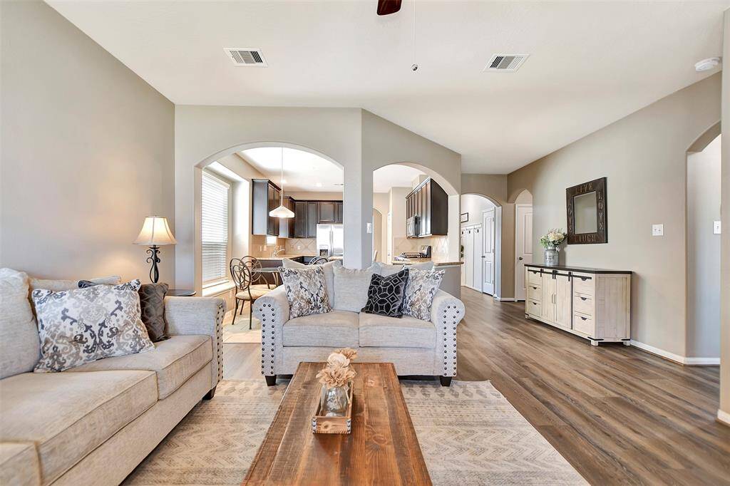 The stylish archways connect the living area with the modern kitchen and dining space, creating a perfect setting for gatherings and entertaining.
