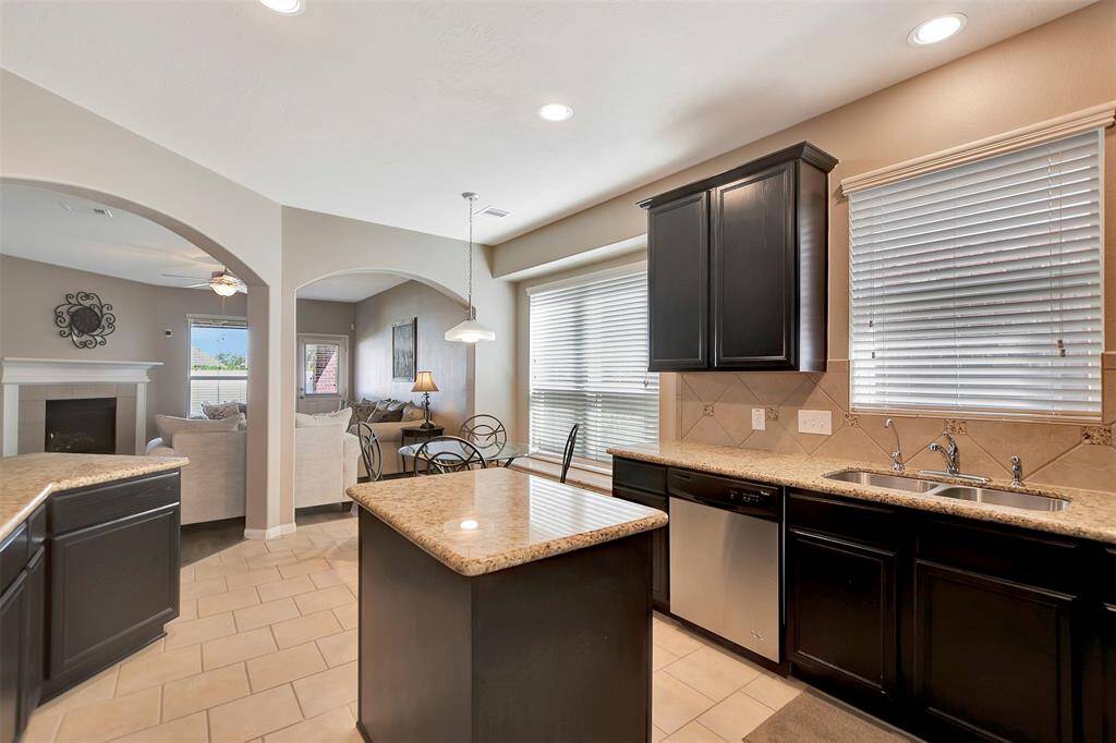 Natural light fills the space through large windows, complemented by modern tile flooring.