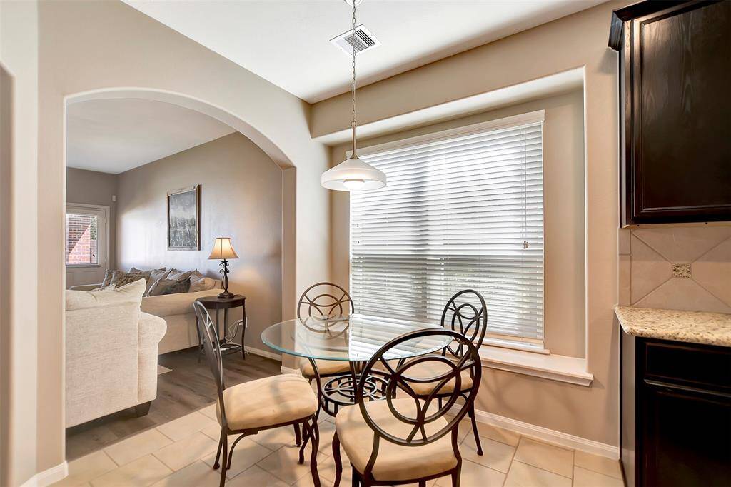 The breakfast area is positioned near a large window allowing natural light. The ledge by the window would be perfect for plants or growing herbs.