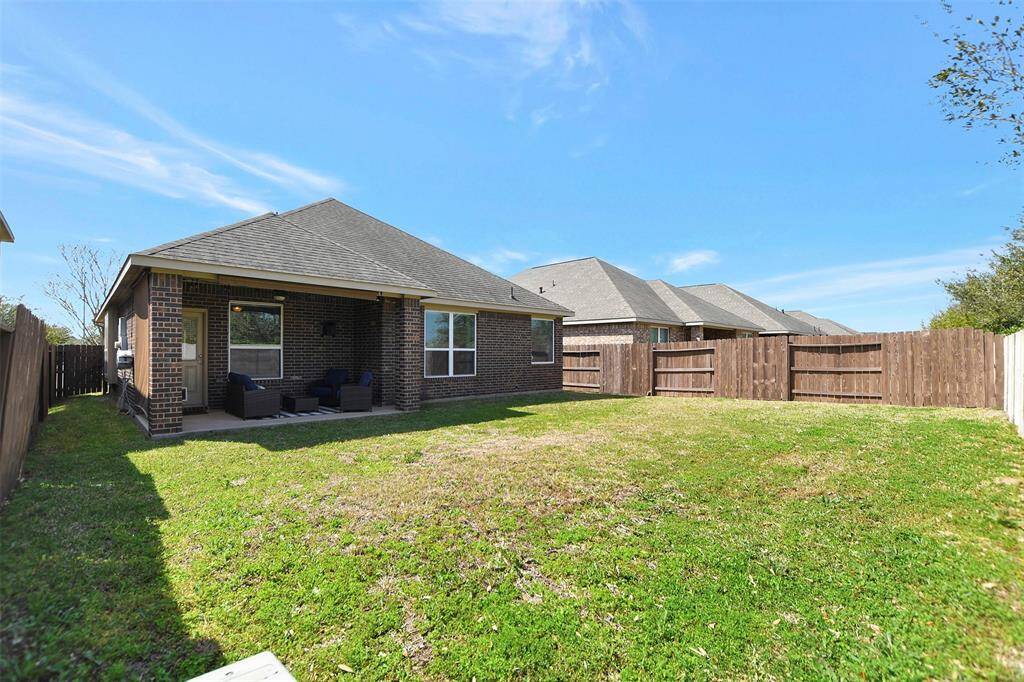 The covered patio is ideal for outdoor relaxation and entertaining.