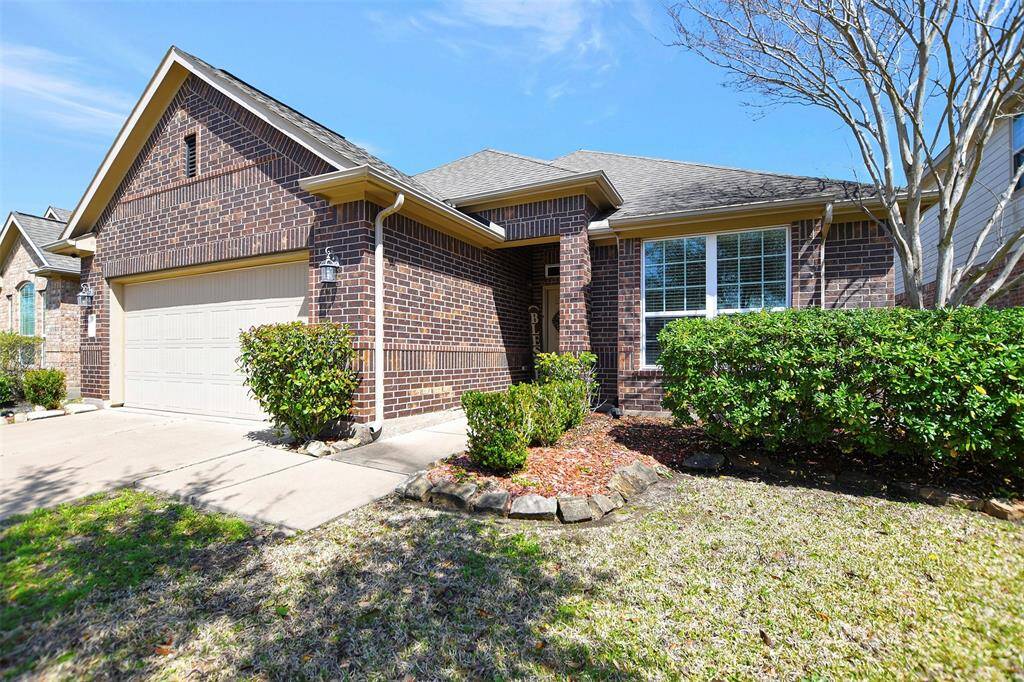 Single-story brick home with a two-car garage.