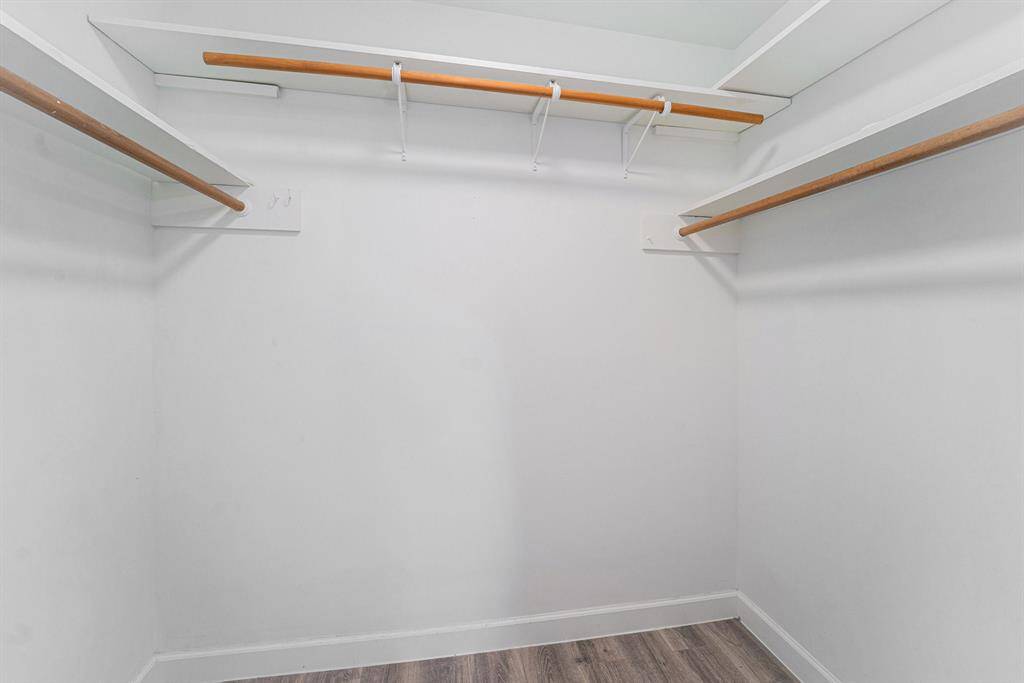 Two Walk in closet with shelves, perfect for organized storage in primary bedroom.