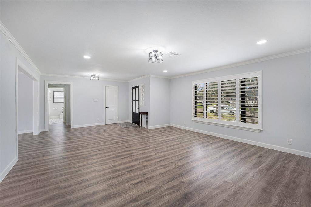 This spacious dining/living area large windows with plantation shutters.