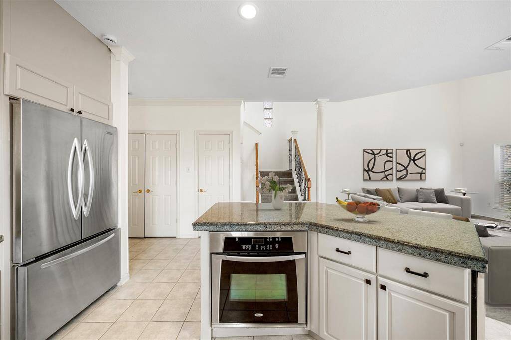 The stairway across the kitchen leads you to the retreat of all bedrooms - your private haven awaits upstairs. *virtually staged*