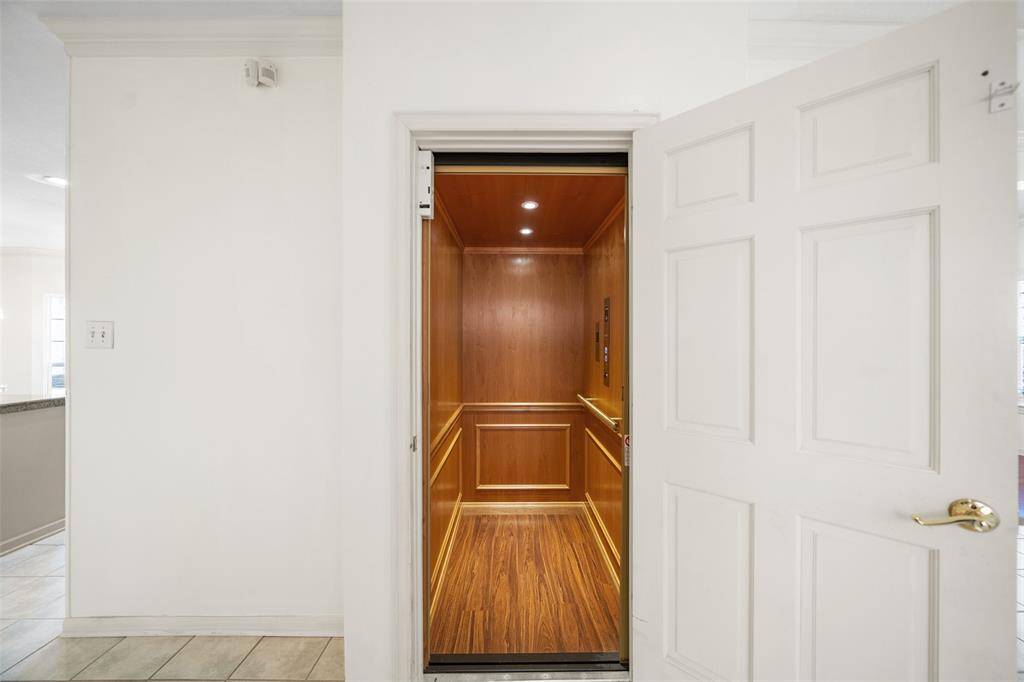 Catch a ride upstairs using the home's private elevator - providing effortless access and added convenience, a rare luxury in the area.