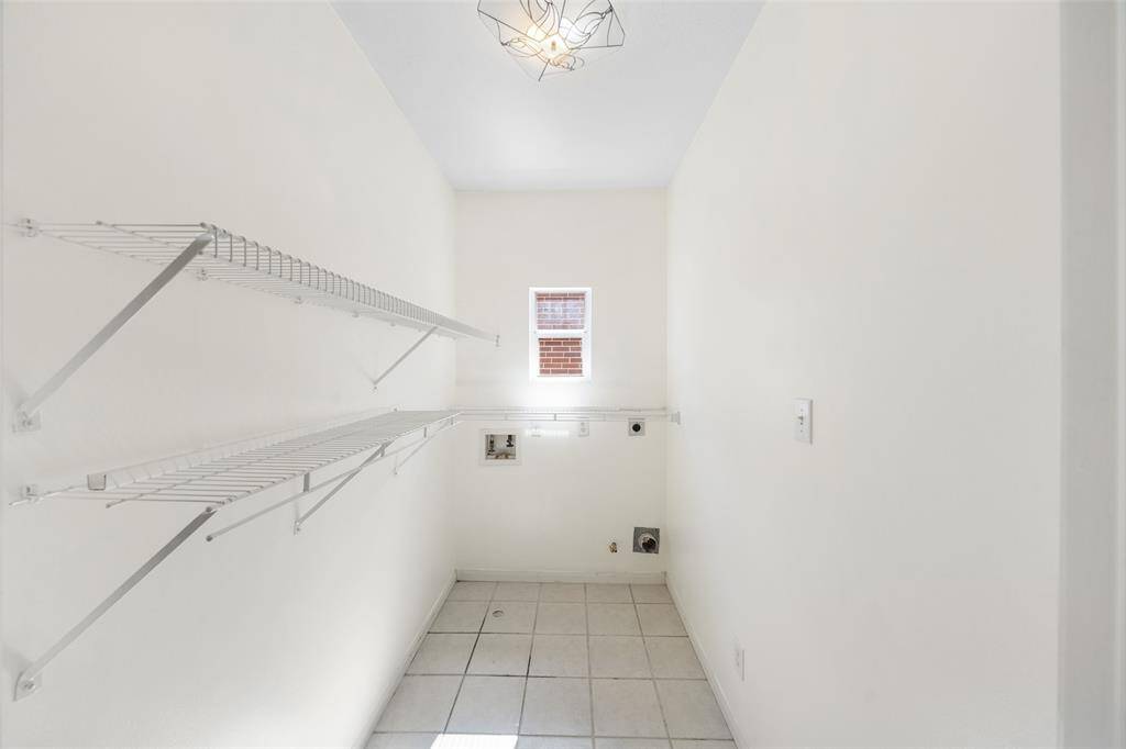 Spacious and functional laundry room with a window - bringing in natural light to make laundry a little more enjoyable.