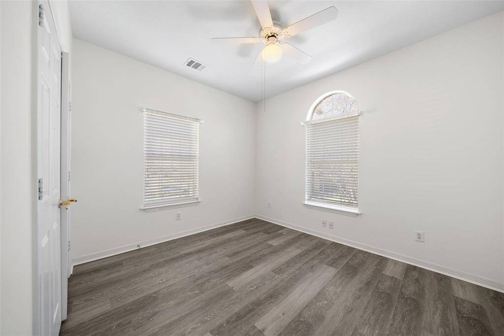 Bright and versatile secondary bedroom with new flooring and ample space for a personalized retreat.