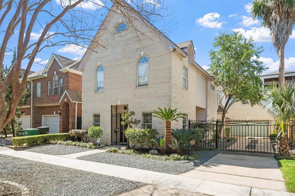 The sprawling 2-story is secured by an automatic driveway gate, leading to a spacious, detached garage.