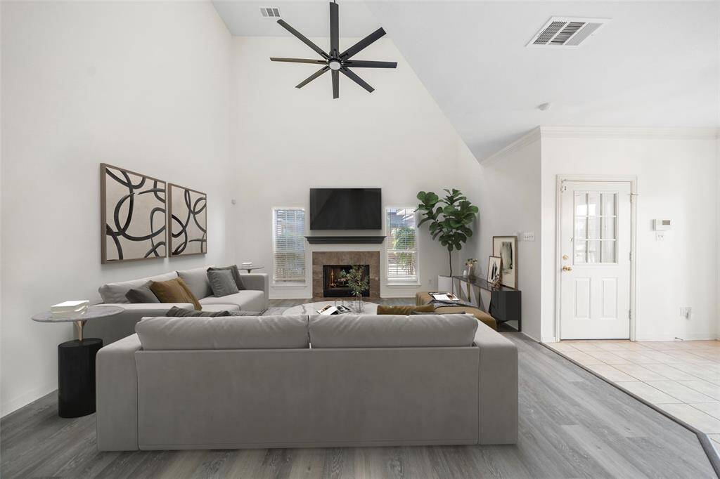 The grand living room features BRAND NEW FLOORING, a cozy fireplace and a view of your quaint backyard, making it easy to keep an eye on children or pets. *virtually staged*