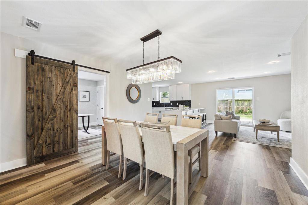 Your friends and family will love breaking bread with you in this elegant formal dining room with stylish lighting and a modern sliding barndoor providing access to the study.