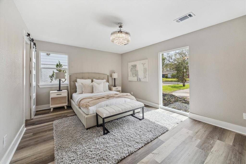 You'll have sweet dreams in this posh owner’s retreat, where luxury vinyl plank flooring, neutral paint, and a chic chandelier set the stage for rest and relaxation.