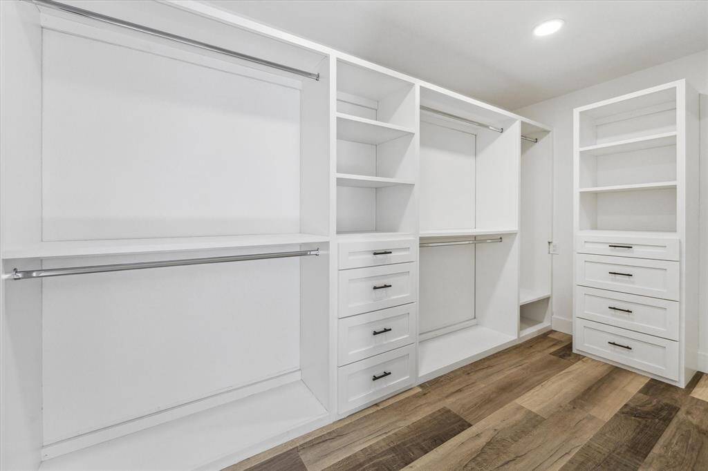 Shop until you drop! This massive walk-in closet is filled with custom storage solutions. You’ll have ample space for hanging clothes, shoes, bags and more.