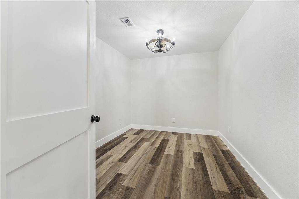 Your family and guests will rest comfortably in this roomy bedroom with LVP flooring, neutral paint, a stylish chandelier large closet and easy access to an updated full bathroom.