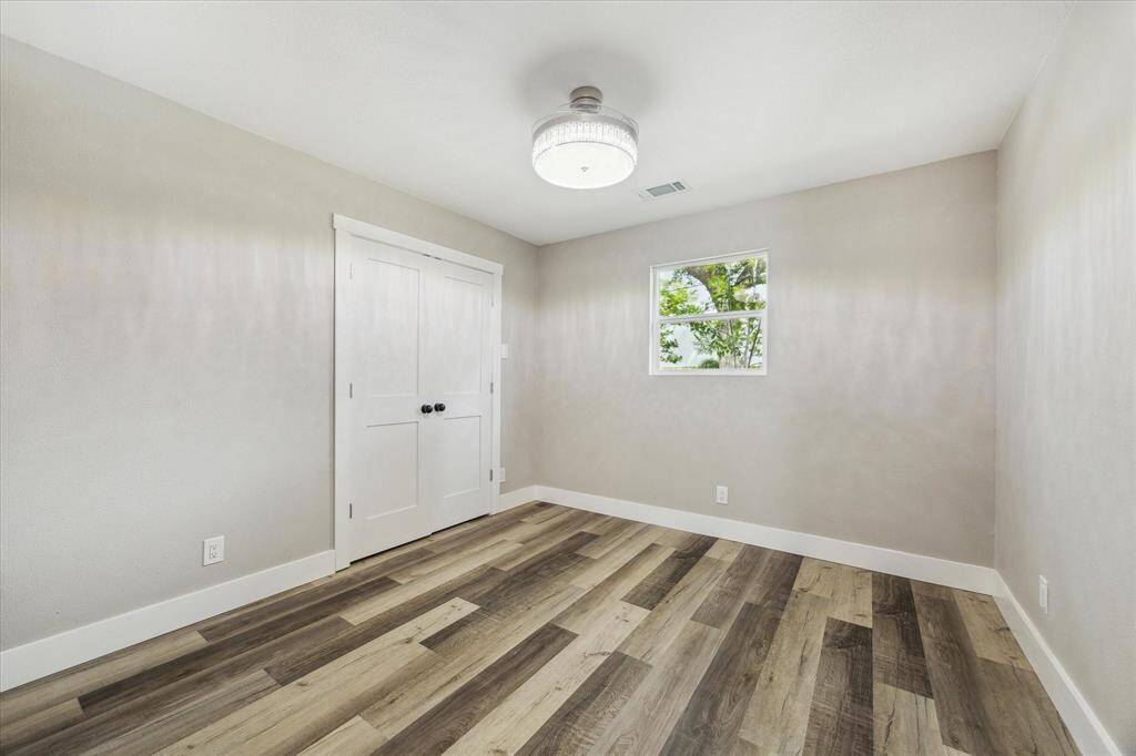 Guests will feel right at home in this inviting bedroom, featuring soft neutral finishes and plenty of space for furnishings and personal touches.