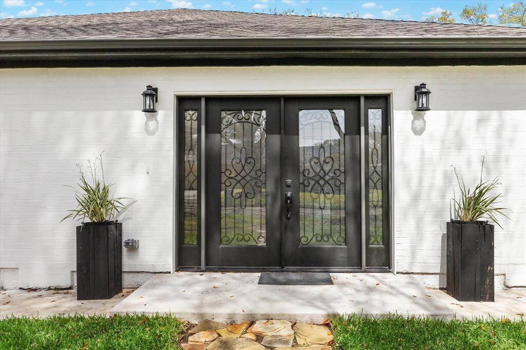 Paired with stylish exterior lighting, these impressive leaded glass front doors with iron inlay set the stage for a grand entrance, inviting you into a home filled with elegant features and thoughtful updates throughout.