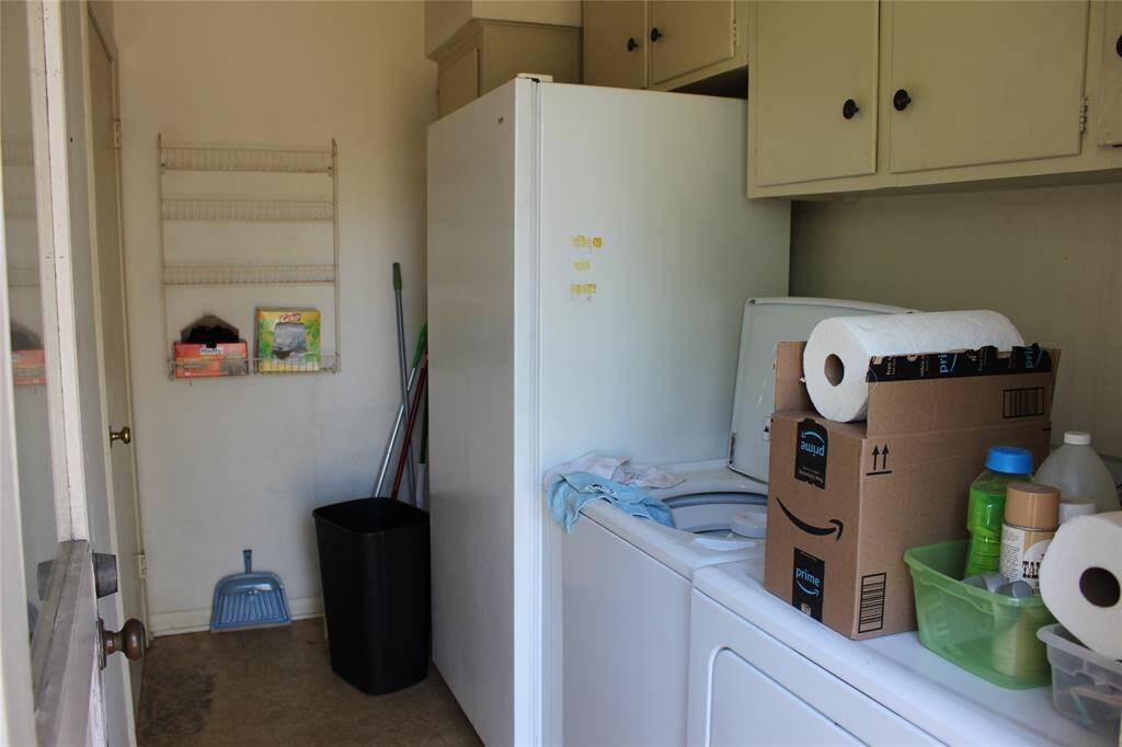 Laundry room has space for a storage closet and an extra fridge/freezer.