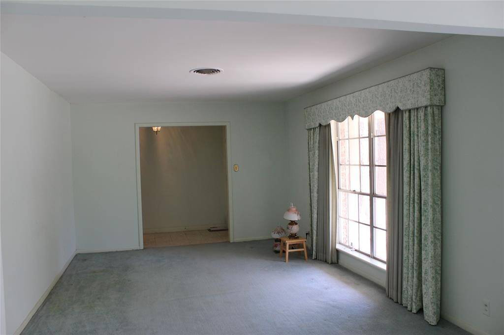 Large window in the formal living room gives you a great view of the front landscape