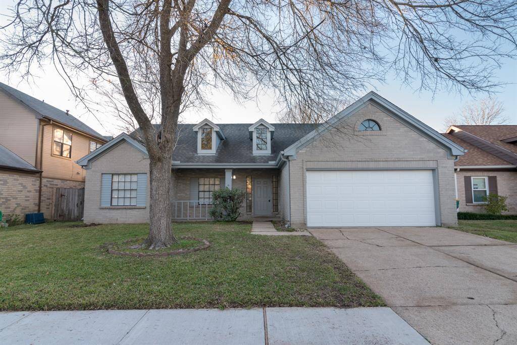 Charming single-story home with a brick exterior, featuring a two-car garage and a cozy front porch. The yard is well-maintained with a prominent tree adding character. Ideal for those seeking a welcoming and comfortable neighborhood setting.
