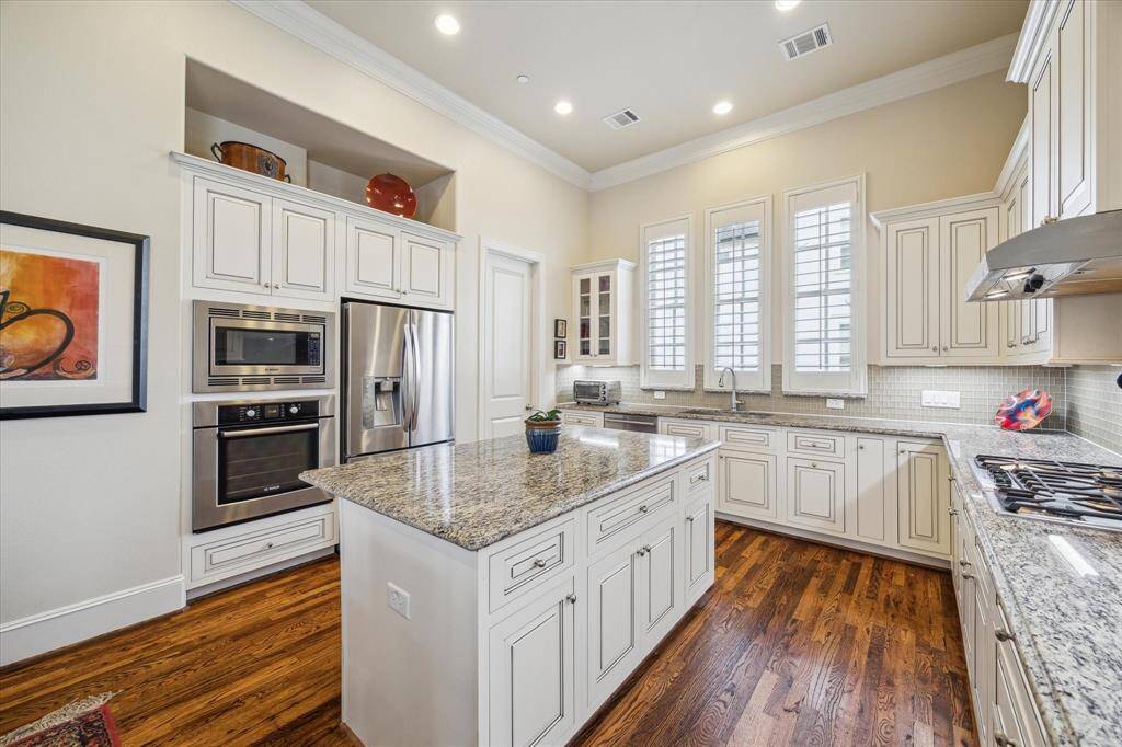 The Kitchen is outfitted with creamy off white cabinets, Bosch appliances and a large walk-in Pantry.