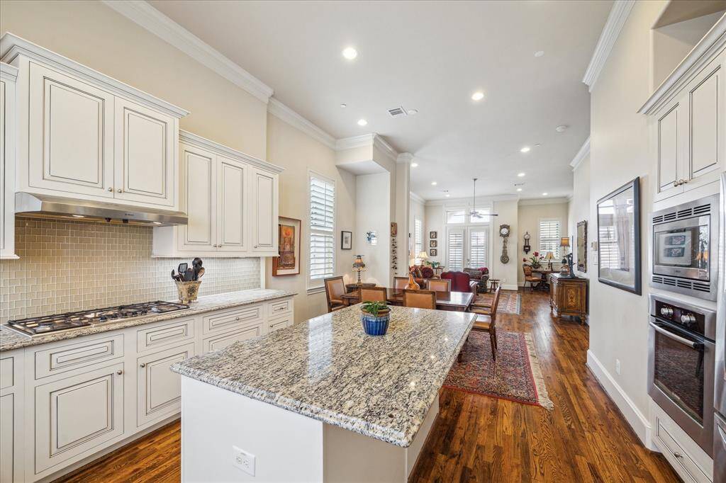 In the center is an Island that would be the perfect spot for Breakfast, for cooling racks of cookies or a buffet.