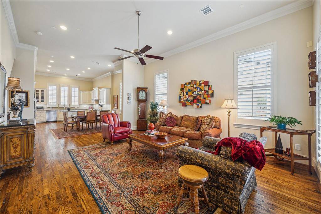 Such a large, lovely space featuring wood floors, plantation shutters on the windows, crown moulding and tons of wall space for furniture and art.