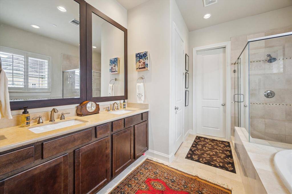 To match the large scale of the Master Bedroom...the Master Bath is equally scaled with a long vanity with drawers and cabinets topped with crema marfil marble, plus marble tiles on the floor.