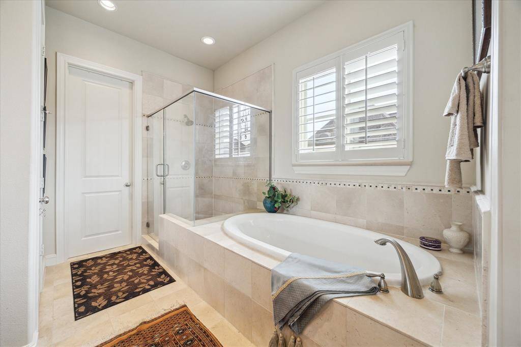 A soaking Tub and oversized Shower give you options when it comes to getting clean. The window allows in natural light while at the same time provides privacy. Within there is also a gargantuan Master Closet as well as a private Water Closet.
