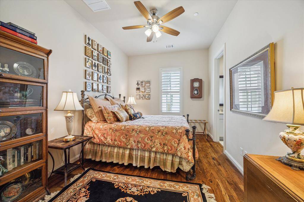 On the Second floor is a second Suite featuring hardwood floors, plantation shutters, and...