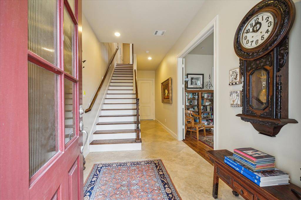A peek inside reveals is a taste of things to come: Light and luxury abound from the travertine Entry to the wood floors throughout.