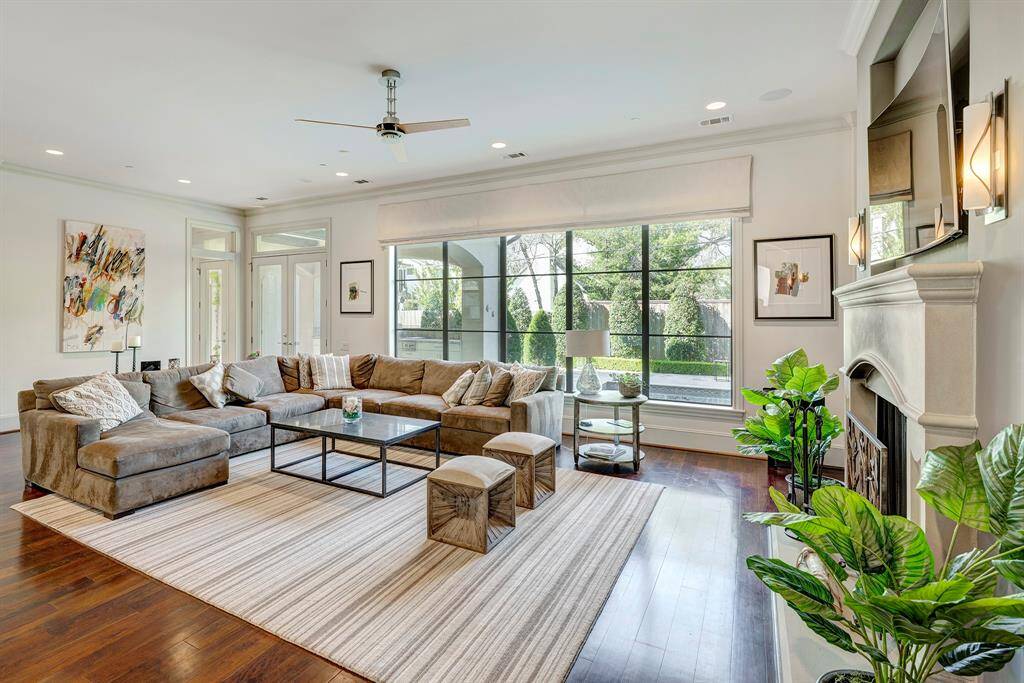 The family room has a fireplace with built ins and a view of pool and back yard, Double doors to the landscaped low maintenance back yard. High ceilings throughout the home.