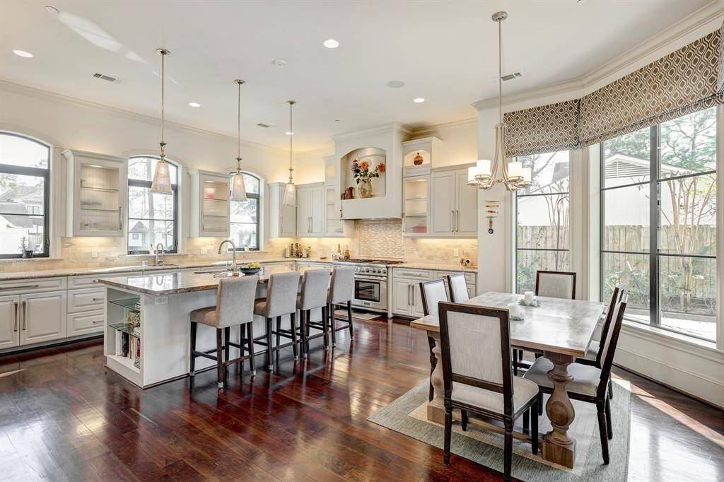 Kitchen blends in with breakfast area and den.Walk in pantry with spice racks on the door.Open tofamily room. One switch turns on all the lights in glass cabinets and under the counters. Love well planned details, don't you? Mercury glass pentacle lights over the island.