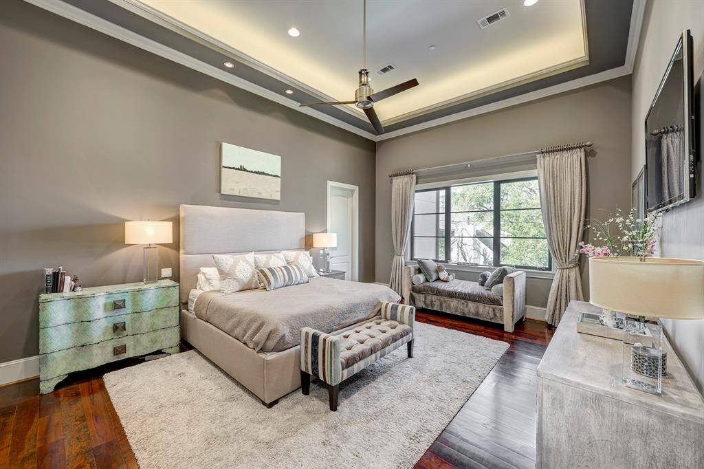 Luxurious Primary Room is spacious. Drapes stay. Notice the romantic recessed ceiling lighting. Door by bed goes to the bathroom.