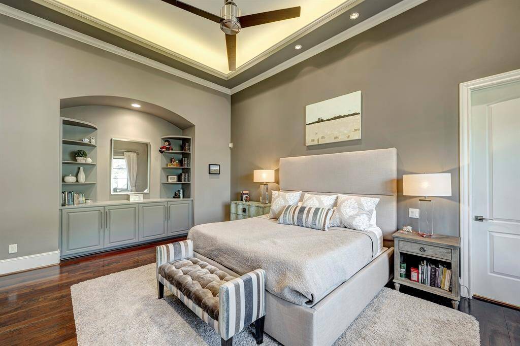 Primary has a custom feature of an alcove -counter and built ins and romantic recessed lighting in the ceiling. Door to the right is to the bathroom.