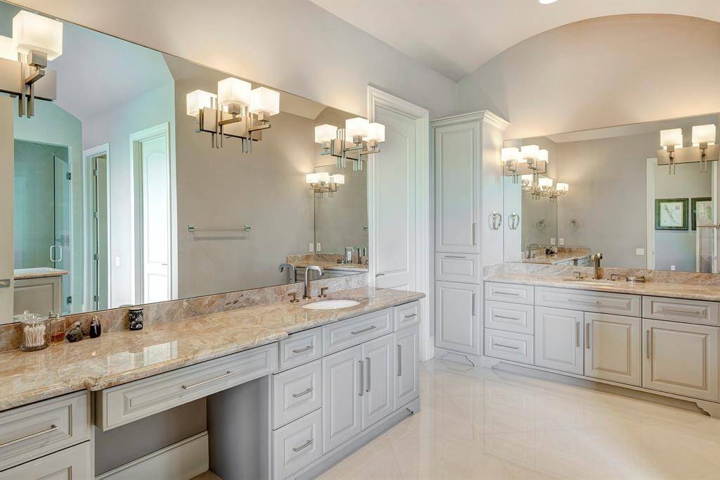 Primary bath has architectural feature -a curved arch; 2 counters-one with a vanity