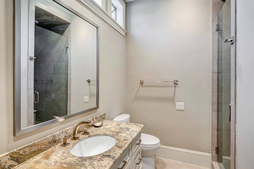 Frameless shower for bedroom closest to laundry; has laundry hamper