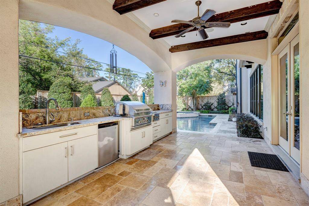 Summer kitchen has smoker-grill,griddle, refrigerator and a sink