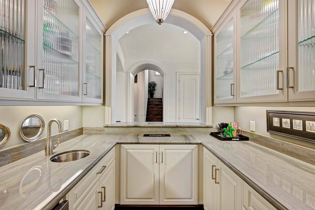 Wet bar counters and glass cabinetry, lights under and in cabinets