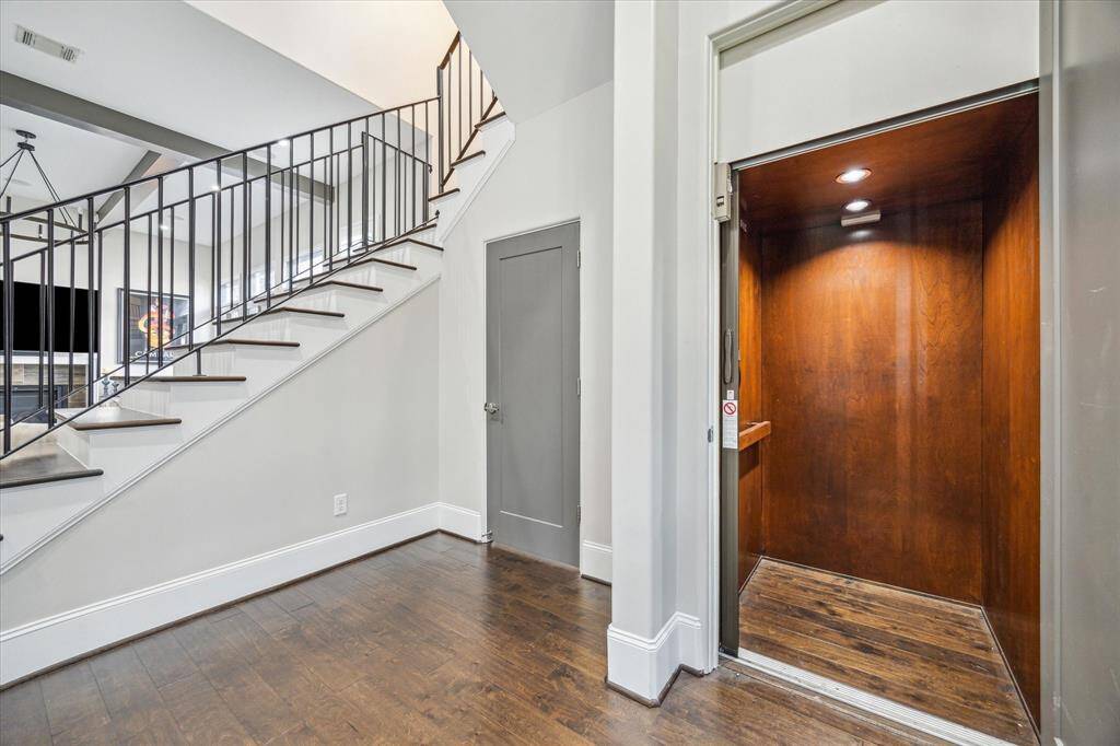 Private elevator located off the main entry hall provides convenient access to all three levels of the home. Hardwood floors and modern iron stair railings add a touch of sophistication.