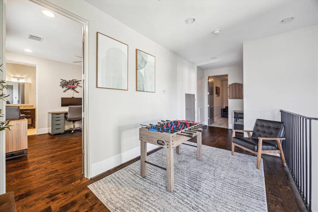 This versatile upstairs loft area connects multiple rooms and includes space for gaming, relaxing, or even a secondary living space.