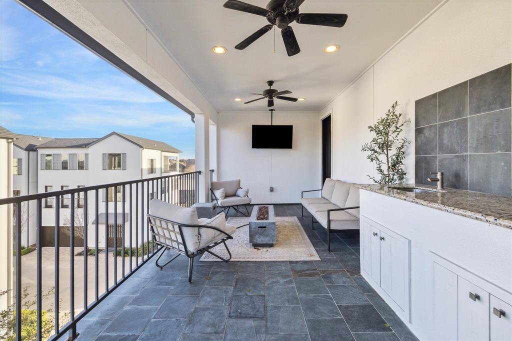 A stunning view from the upper balcony showcases the tranquility and privacy this home offers, nestled among lush mature trees.