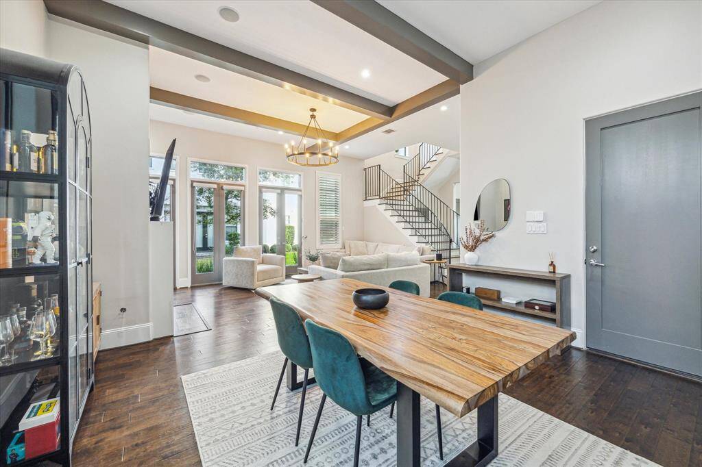 Dining area positioned perfectly between the living room and kitchen, ideal for both casual meals and dinner parties. Thoughtful accents and a modern chandelier complete the look.