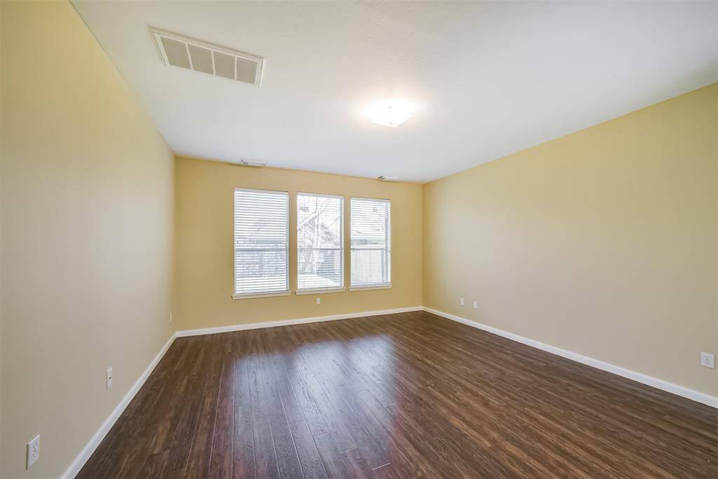 Three air vents and large windows make this primary bedroom a perfect retreat.