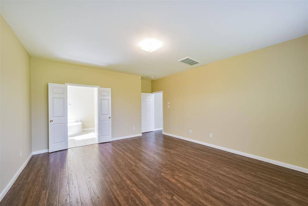 French doors lead you to the primary's ensuite bathroom.