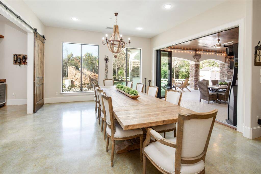 The dining room is filled with natural light & on nice days can easily extend outside thanks to the custom bi-fold patio doors